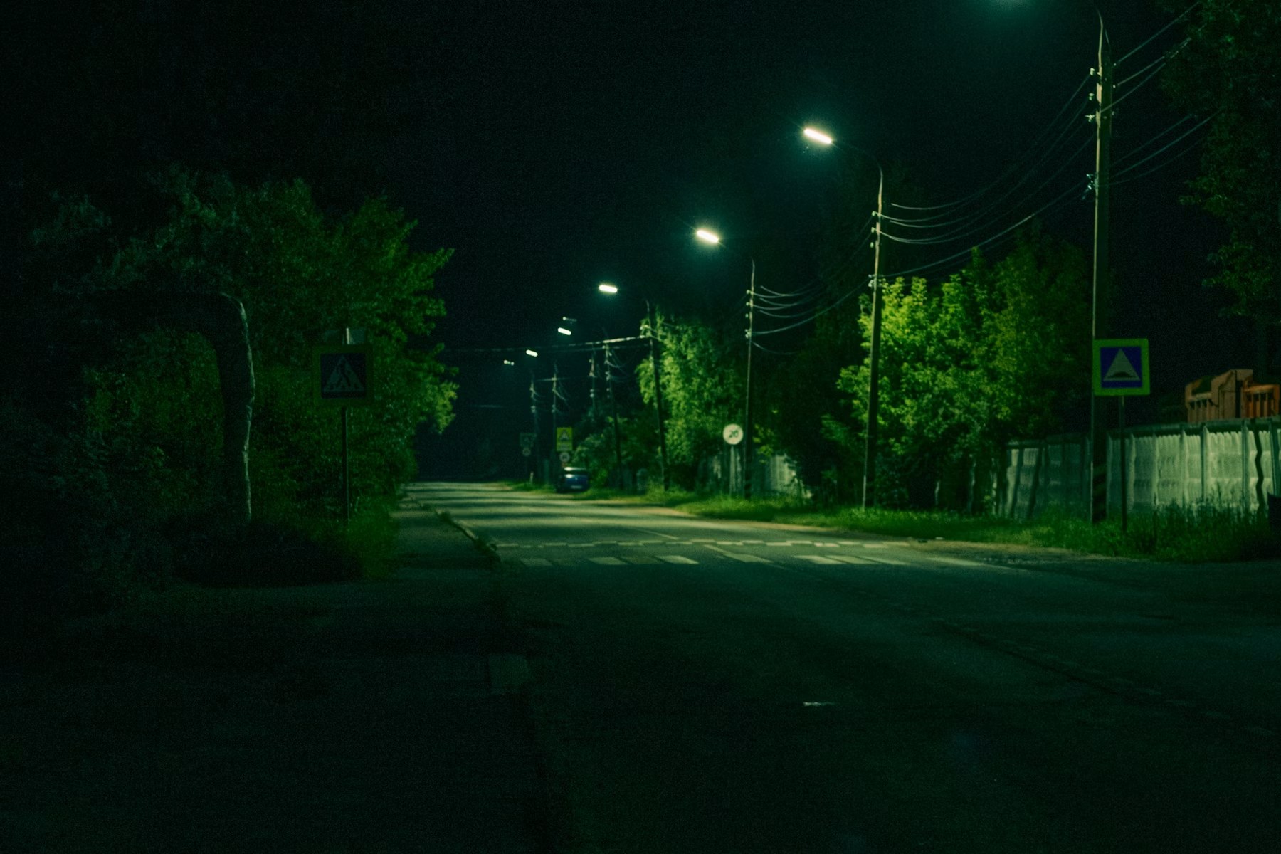 Jalan yang tenang pada malam hari diterangi lampu jalan